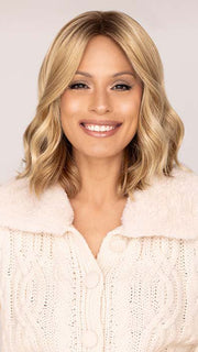 Roxie wearing CHARLOTTE in color SPARKLING CHAMPAGNE | Medium Brown roots with overall Strawberry Blonde base and soft Golden Blonde highlights