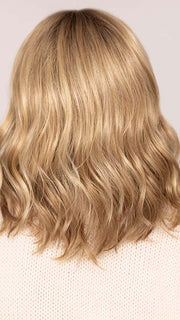 Roxie wearing CHARLOTTE in color SPARKLING CHAMPAGNE | Medium Brown roots with overall Strawberry Blonde base and soft Golden Blonde highlights