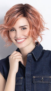 Model is in ROSE BLUSH ROOTED | Light copper, Peach, and Soft Rose Gold tones with subtle Golden Undertones and Shaded Roots
