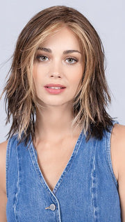 Model is wearing COFFEE BROWN LIGHTED | Dark Brown and Medium Warm Brown with Medium Blonde Blends with Highlights Throughout and Concentrated in the Front