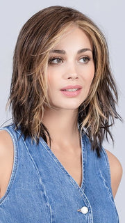 Model is wearing COFFEE BROWN LIGHTED | Dark Brown and Medium Warm Brown with Medium Blonde Blends with Highlights Throughout and Concentrated in the Front