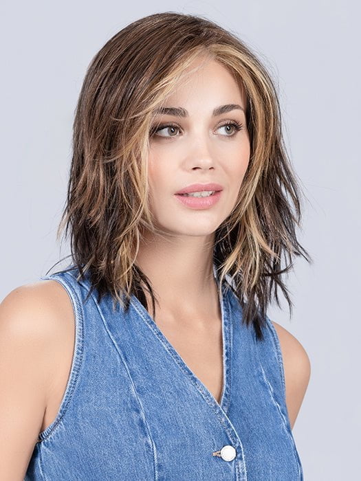 Model is wearing COFFEE BROWN LIGHTED | Dark Brown and Medium Warm Brown with Medium Blonde Blends with Highlights Throughout and Concentrated in the Front