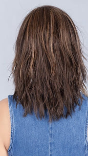Model is wearing COFFEE BROWN LIGHTED | Dark Brown and Medium Warm Brown with Medium Blonde Blends with Highlights Throughout and Concentrated in the Front