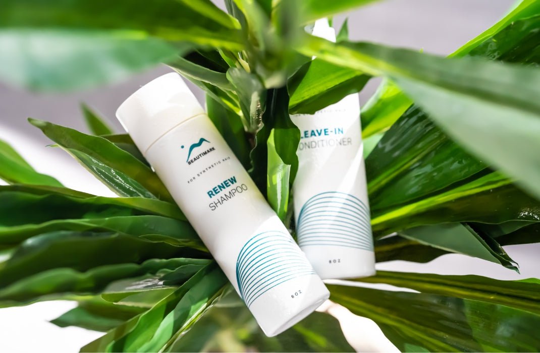 Beautimark synthetic renew shampoo and leave-in conditioner sitting in a plant