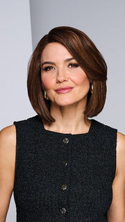 Model is wearing LONGING FOR LONDON by RAQUEL WELCH in color RH9/24SS SHADED CAFE LATTE | Dark Brown with Golden Brown highlights from dark roots to ends
