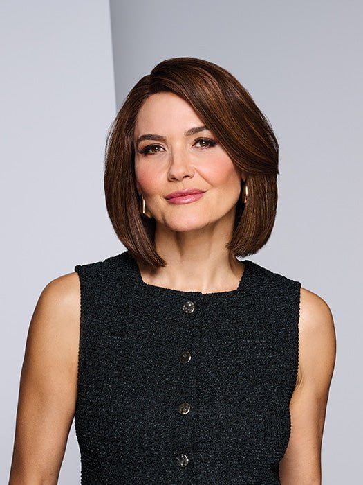 Model is wearing LONGING FOR LONDON by RAQUEL WELCH in color RH9/24SS SHADED CAFE LATTE | Dark Brown with Golden Brown highlights from dark roots to ends