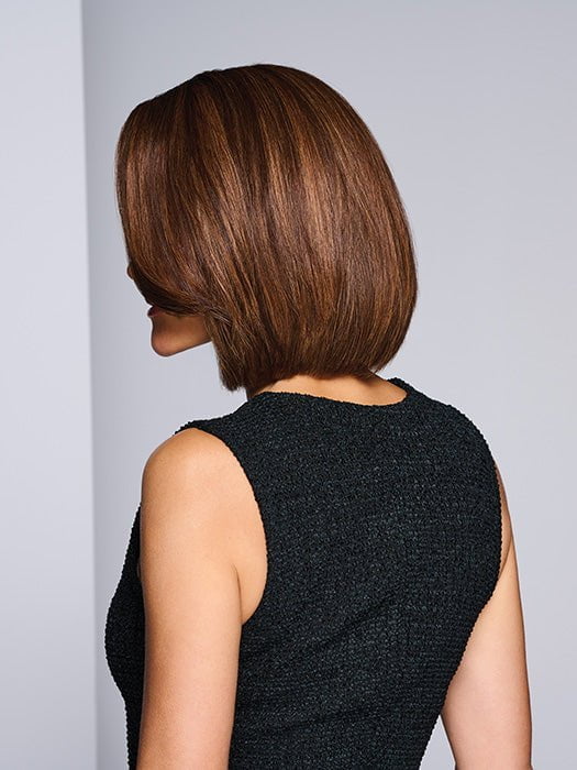 Model is wearing LONGING FOR LONDON by RAQUEL WELCH in color RH9/24SS SHADED CAFE LATTE | Dark Brown with Golden Brown highlights from dark roots to ends