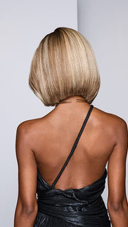 Model is wearing LONGING FOR LONDON by RAQUEL WELCH in color RH13/25SS SHADED PRALINE | Neutral Medium Blond with Medium Golden Blonde highlights that extend from dark roots to ends