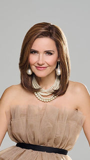 Model is wearing MIDNIGHT IN PARIS by RAQUEL WELCH in color RH8 8/29SS SHADED HAZELNUT | Warm Medium Brown with Ginger Blonde highlights from dark roots to ends