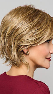 Model is wearing MAIN CHARACTER by RAQUEL WELCH in RL 13/88 GOLDEN PECAN | Neutral Medium Blonde With Pale Honey Blonde Highlight