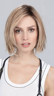 Model is wearing SAND MULTI ROOTED | Lightest Brown and Light Neutral Blonde with Light Reddish Auburn Blend and Shaded Roots