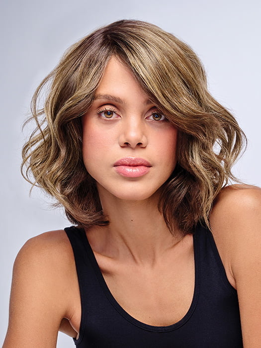 Model is wearing 10" AU NATUREL WAVES TOPPER in color SS9/24 ICED CAFÉ LATTE | Dark Brown shaded with Golden Brown