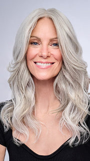 Model is wearing 16" AU NATUREL WAVES TOPPER by HAIRDO in color R56/60 SILVER MIST | Lightest Gray with 20% Medium Brown Evenly Blended with Pure White