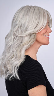 Model is wearing 16" AU NATUREL WAVES TOPPER by HAIRDO in color R56/60 SILVER MIST | Lightest Gray with 20% Medium Brown Evenly Blended with Pure White