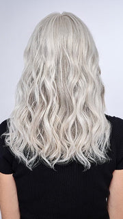 Model is wearing 16" AU NATUREL WAVES TOPPER by HAIRDO in color R56/60 SILVER MIST | Lightest Gray with 20% Medium Brown Evenly Blended with Pure White