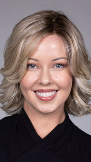 Model is wearing HELSINKI by BELLETRESS in color CRUSHED ALMOND BLONDE R | A soft Neutral Light Blonde with a Light and Medium Blended Root Color.
