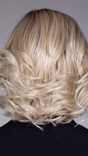 Model is wearing HELSINKI by BELLETRESS in color CRUSHED ALMOND BLONDE R | A soft Neutral Light Blonde with a Light and Medium Blended Root Color.