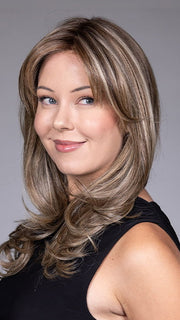 Model is wearing MARSEILLE by BELLETRESS in color MACADAMIA LATTE R | A combination of Medium and Light Brown, highlighted with Light Gold Blonde, and a mixture of Ash Blonde and Light Gold Blonde, Rooted with Medium and Light Brown