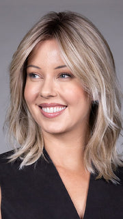 Model is wearing MONACO by BELLETRESS in color MILKSHAKE BLONDE R | A mixture of Light Sandy Brown, Highlighted with Light Ash Blonde with a Hint of Light Platinum Blonde with a Medium Root Color