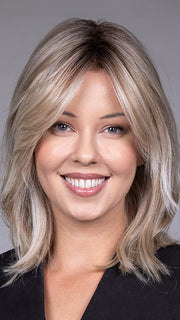 Model is wearing MONACO by BELLETRESS in color MILKSHAKE BLONDE R | A mixture of Light Sandy Brown, Highlighted with Light Ash Blonde with a Hint of Light Platinum Blonde with a Medium Root Color