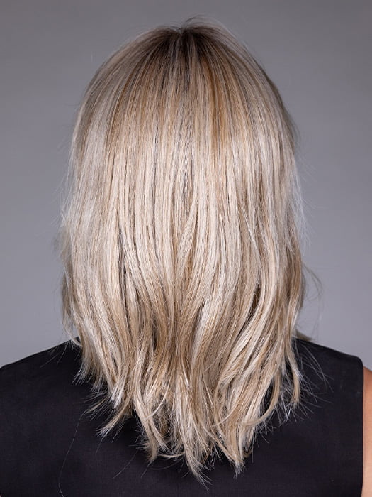 Model is wearing MONACO by BELLETRESS in color MILKSHAKE BLONDE R | A mixture of Light Sandy Brown, Highlighted with Light Ash Blonde with a Hint of Light Platinum Blonde with a Medium Root Color