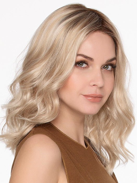 Model is wearing MOLLY by ENVY in SILKY BEIGE | Light Platinum Blonde with Dark Brown Roots