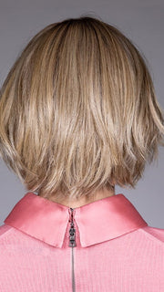 Model is wearing OSLO by BELLETRESS in color RAW SUGAR BLONDE | A Neutral Light Blonde, Honey Blonde, Pale Gold Blonde, with a base of Light Brown Lowlights featuring a Medium Root Color