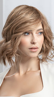 Model is wearing Supreme Plus Deluxe in color TOBACCO ROOTED 12.26.27 | Medium Brown Blended with Light Auburn, Lightest Brown, and Dark Strawberry Blonde Blend with Shaded Roots