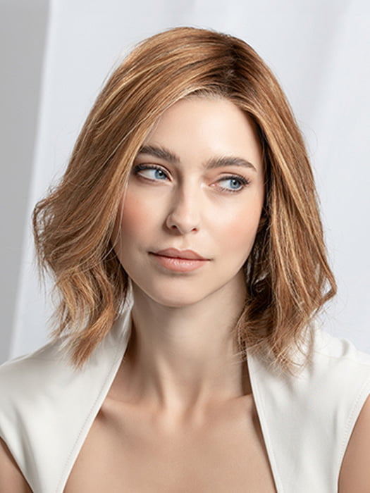 Model is wearing Supreme Plus Deluxe in color TOBACCO ROOTED 12.26.27 | Medium Brown Blended with Light Auburn, Lightest Brown, and Dark Strawberry Blonde Blend with Shaded Roots