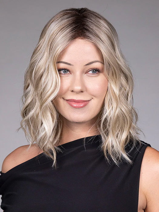 Model is wearing ANDIE in color BUTTER BEER R | A rich blend of warm brunette and golden honey highlights finished with a soft, natural root.