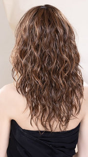 Model is wearing SERENA in BAHAMA BEIGE | Medium Honey Blonde, Light Ash Blonde, and Lightest Reddish Brown blend