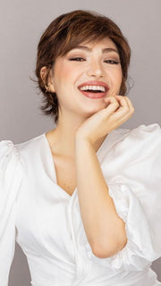 Maha is wearing the VOLTAGE by RAQUEL WELCH in color R829S+ GLAZED HAZELNUT | Rich Medium with Ginger Highlights on Top