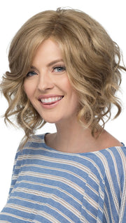 Her loose waves and stacked back allow for fullness that won't weigh you down