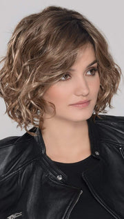 A trendy, mid length style with perfectly placed layers. The monofilament part placement offers the perfect amount of volume