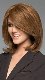 Tiffany is a medium length shag cut, showing off subtle volume and side swept bangs that accent the face
