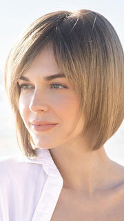 CODI by Amore in MACADAMIA-LR | The root is soft brown color that melts into a beige blonde color.
