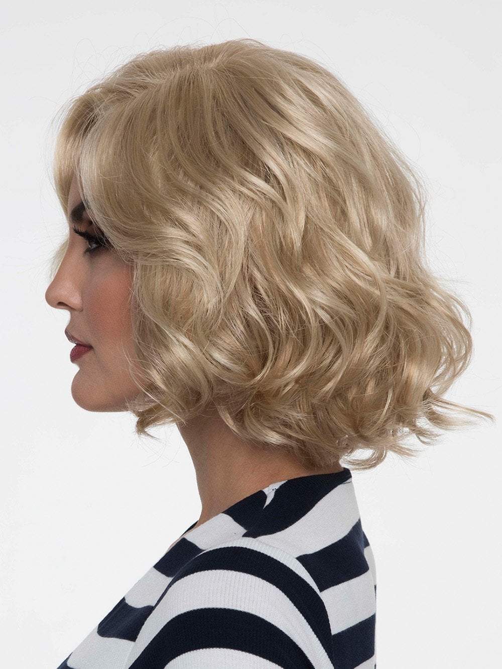 Coco's artfully curled layers add a touch of flirty sophistication
