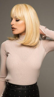 The full bang frames the face and can be trimmed or pushed to the side
