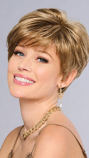 This style features soft layering throughout, asymmetrical tapered bangs, and closely cropped nape