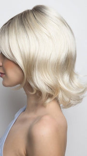 A mid-length wig with a full fringe and bouncy salon look