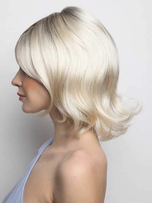 A mid-length wig with a full fringe and bouncy salon look