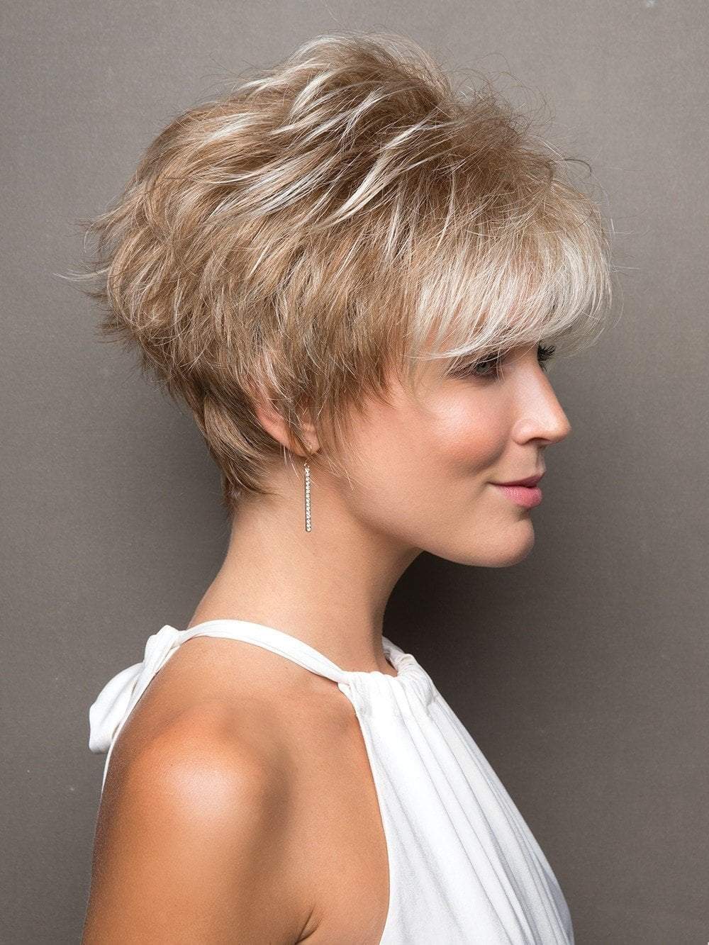 Bold multi-layered style is full of texture and hugs the nape with tapered edges.