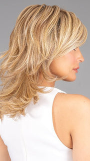 A bi-level tousled shag falling below the shoulder