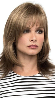 Features long layers and wispy face framing bangs | Color: Almond Breeze