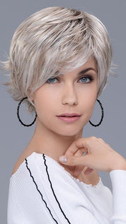The natural lacefront hairline is complimented with softly textured bangs and can be swept to the side