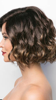 A short, flirty bob with a side swept fringe. With her tousled waves that give this style the perfect amount of volume to flatter any face shape